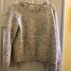A cream sweater with specks of color